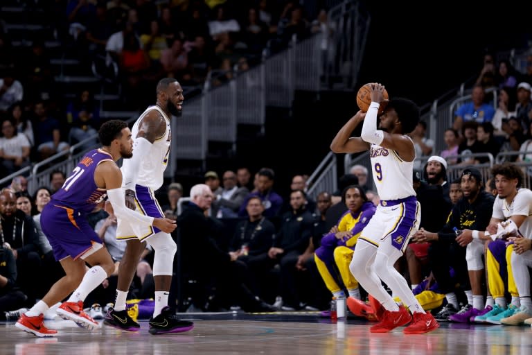 Bronny James (right) prepares to shoot as father LeBron James (left) looks on in the Los Angeles Lakers' pre-season game in Palm Desert on Sunday (Katelyn Mulcahy)