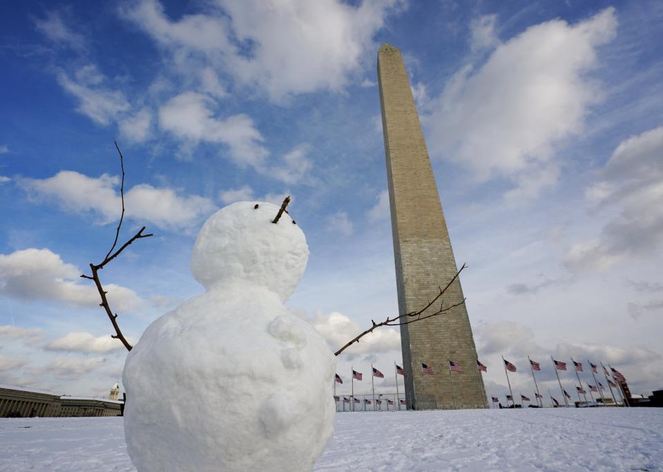 A snowman is built in front of the Washington Monument on the National Mall after a snowfall in Washington (REUTERS)