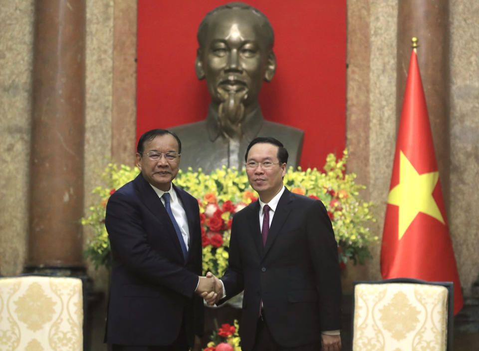 Vietnamese President Vo Van Thuong, right, shakes hands with Cambodian Foreign Minister Prak Sokhonn, left, in Hanoi, Vietnam on Tuesday, March 21, 2023. Sokhonn is on a visit to Vietnam to discuss bilateral relations with Vietnamese leaders. (AP Photo/Hau Dinh)
