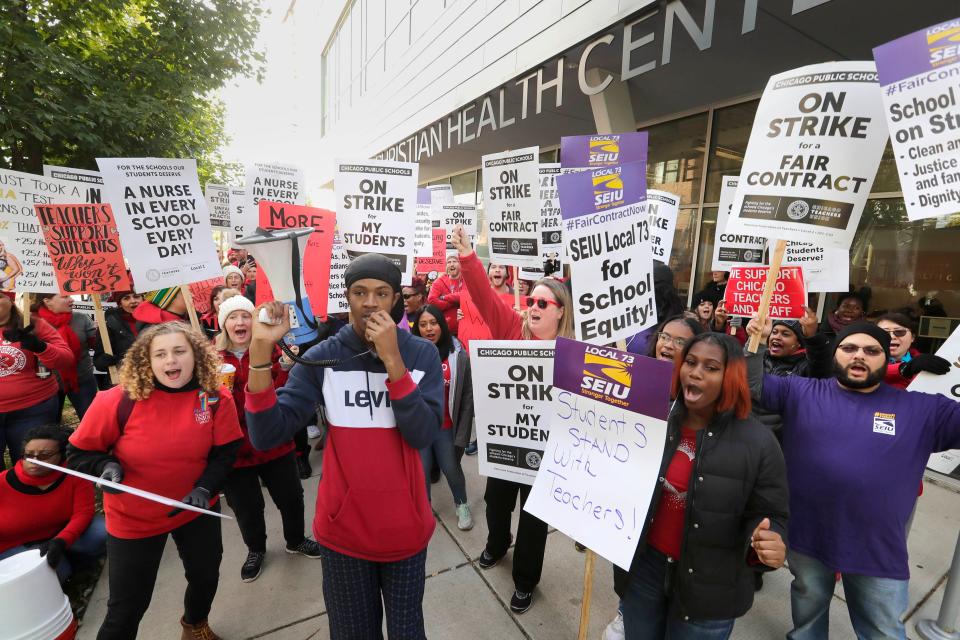 Kaleb Autman, a supporter of the strike, leads teachers and SEIU supporters at Breakthrough, a non-profit for those affected by poverty. Chicago Mayor Lori Lightfoot later read a book to children at the center.