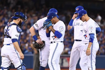 Oct 17, 2016; Toronto, Ontario, CAN; Toronto Blue Jays starting pitcher Marcus Stroman (center) reacts while being relieved during the sixth inning in game three of the 2016 ALCS playoff baseball series against the Cleveland Indians at Rogers Centre. Mandatory Credit: Nick Turchiaro-USA TODAY Sports