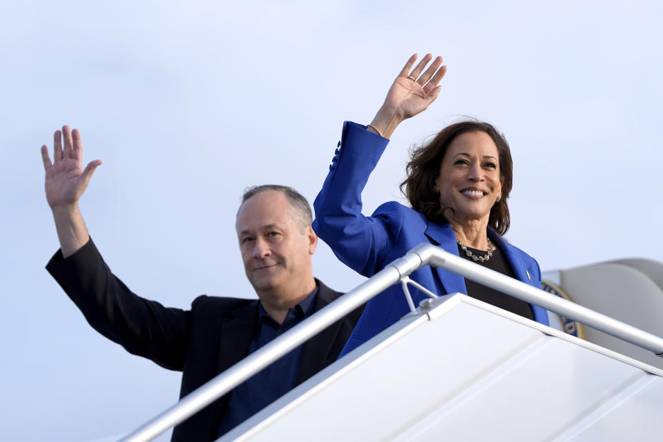 Democratic presidential nominee Vice President Kamala Harris, right, and second gentleman Doug Emhoff wave as they board Air Force Two at Pittsburgh International Airport, Sunday, Aug. 18, 2024, in Pittsburgh. (AP Photo/Julia Nikhinson)