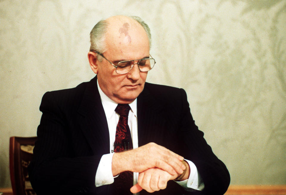 FILE - Soviet President Mikhail Gorbachev checks the time on his watch before his resignation speech in the Kremlin on Wednesday, Dec. 25, 1991, drawing a line under more than 74 years of Soviet history. By the fall of 1991, however, deepening economic woes and secessionist bids by Soviet republics had made the collapse all but inevitable. The failed August 1991 coup by the Communist old guard was a major catalyst, dramatically eroding Gorbachev’s authority and encouraging more republics to seek independence. (AP-Photo/Liu Heung Shing, File)