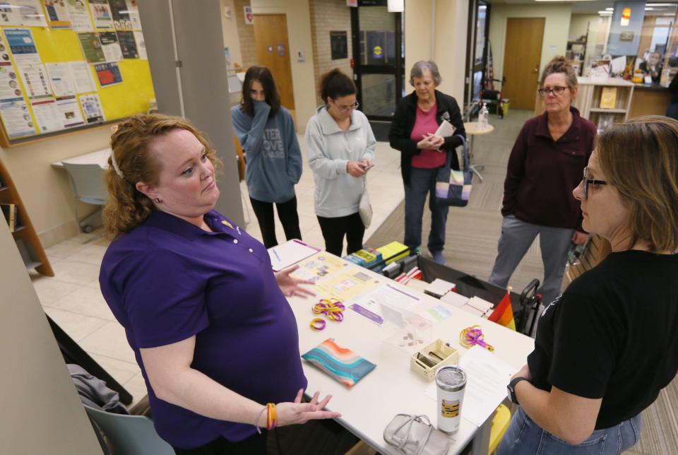 Sara Hayden Parris from Annie's Foundation distributes free banned books in Iowa to make challenged books more accessible during a Banned Book Wagon tour at Nevada Library on Wednesday, Nov. 15, 2023, in Ames. Iowa.