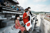 Limited numbers of fans watch in the Fuji International Speedway during the men's cycling road race at the 2020 Summer Olympics, Saturday, July 24, 2021, in Oyama, Japan. (AP Photo/Thibault Camus)