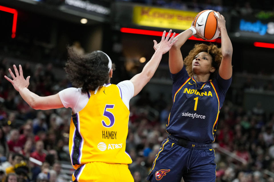 Indiana Fever forward NaLyssa Smith (1) shoots over Los Angeles Sparks forward Dearica Hamby (5) in the first half of a WNBA basketball game in Indianapolis, Tuesday, May 28, 2024. (AP Photo/Michael Conroy)