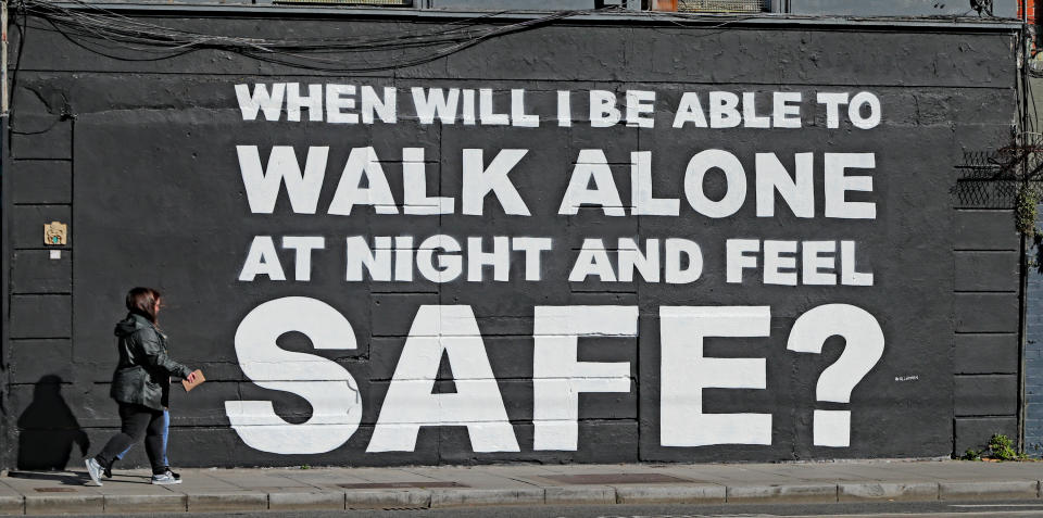 A member of the public walks past the latest mural by Irish artist Emmalene Blake in Dublin's city centre. The inscription 'When will I be able to walk alone at night and feel safe?' relates to violence against women in the wake of the death of Sarah Everard. Picture date: Monday March 29, 2021.