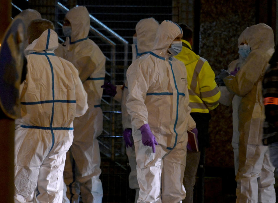 Forensic experts wait to enter the building after several people have been killed or seriously injured in a shooting at a building housing a Kingdom Hall of Jehovah's Witnesses in the northern German city of Hamburg, Germany, March 10, 2023.     REUTERS/Fabian Bimmer