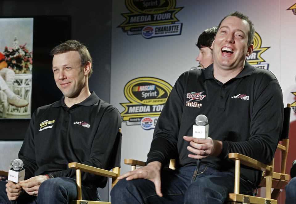 Drivers Kyle Busch, right, and Matt Kenseth, left, share a laugh during a news conference at the NASCAR Sprint Cup auto racing Media Tour in Charlotte, N.C., Thursday, Jan. 30, 2014. (AP Photo)