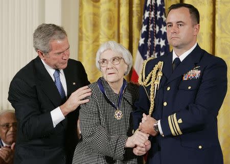 U.S. President George W. Bush (L) awards the Presidential Medal of Freedom to American novelist Harper Lee (C) in the East Room of the White House in a November 5, 2007 file photo. REUTERS/Larry Downing/Files