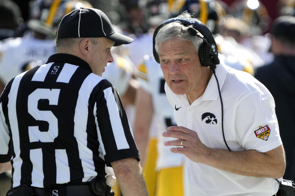 Iowa head coach Kirk Ferentz has words with side judge Tony Tarantini during the first half of the Citrus Bowl NCAA college football game, Monday, Jan. 1, 2024, in Orlando, Fla. (AP Photo/John Raoux)