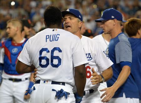August 14, 2018; Los Angeles, CA, USA; Los Angeles Dodgers bench coach Bob Geren (16) holds back right fielder Yasiel Puig (66) against San Francisco Giants catcher Nick Hundley (5) in the seventh inning at Dodger Stadium. Gary A. Vasquez-USA TODAY Sports