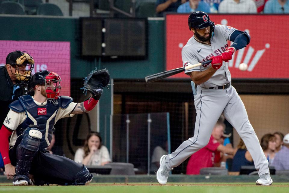 Cleveland Guardians' Amed Rosario swings at a pitch in the top of the first inning of a baseball game against the Texas Rangers in Arlington, Texas, Saturday, July 15, 2023. (AP Photo/Emil T. Lippe)