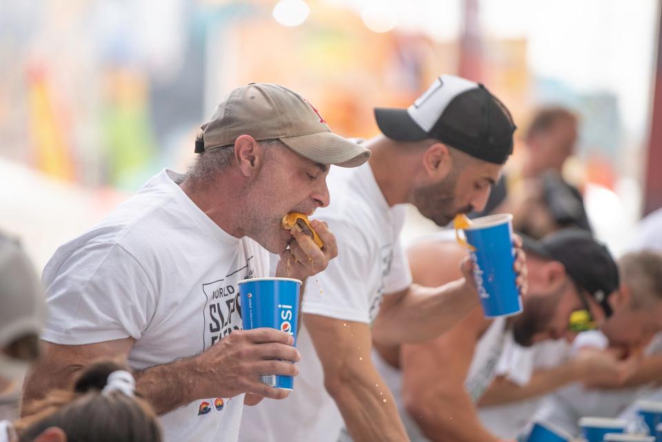 Geoffrey Esper scarfs down one of 31.5 sloppers during the 2023 World Slopper Eating Championship at the Colorado State Fair in Pueblo on Saturday, September 1, 2023.