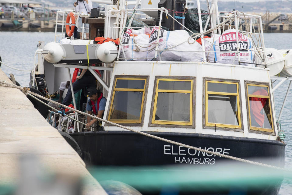 Personnel work on the German rescue boat Eleonore as it docks in the port of Pozzallo, Sicily, Southern Italy, Monday, Sept. 2, 2019. Italy’s interior minister is vowing to make the charity boat with some 100 rescued migrants aboard pay dearly for docking in Sicily in defiance of a government ban. (Francesco Ruta/ANSA via AP)