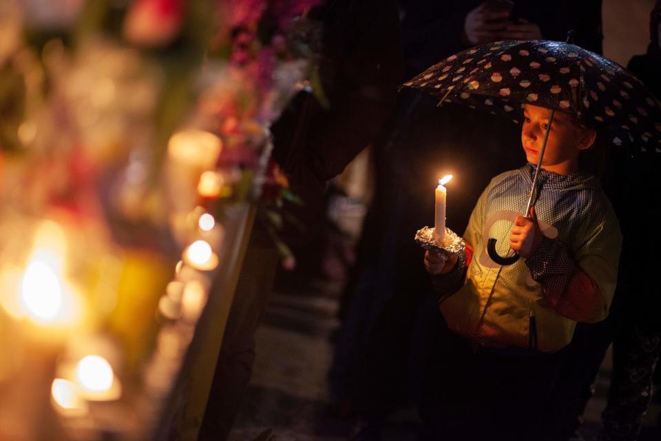 <p>A little girl holds a candle during a vigil on April 24, 2018 in Toronto, Canada, near the site of a deadly street van attack. (Photo: Geoff Robins/AFP/Getty Images) </p>