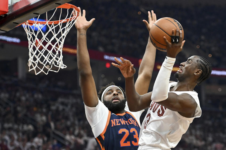 Cleveland Cavaliers' Caris LeVert shoots against New York Knicks' Mitchell Robinson during the first half of Game 1 in a first-round NBA basketball playoffs series Saturday, April 15, 2023, in Cleveland. (AP Photo/Nick Cammett)