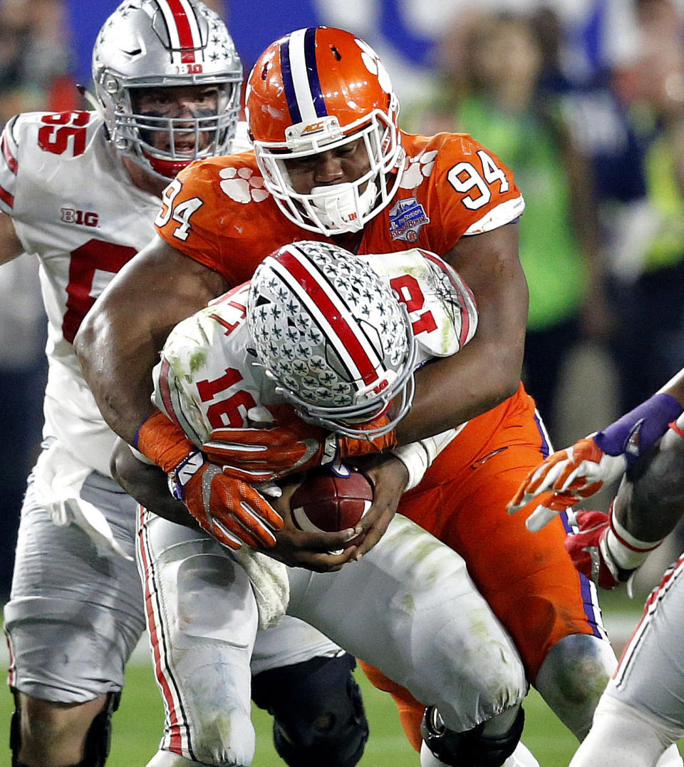 Clemson defensive tackle Carlos Watkins (94) sacks Ohio State quarterback J.T. Barrett (16) during the second half of the Fiesta Bowl NCAA college football playoff semifinal, Saturday, Dec. 31, 2016, in Glendale, Ariz. (AP Photo/Ross D. Franklin)