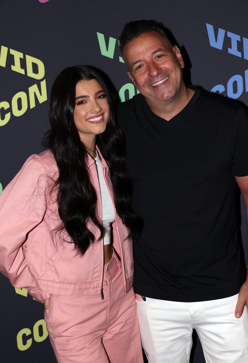 Charli D'Amelio and father Marc D'Amelio attend 2022 VidCon at Anaheim Convention Center on June 23, 2022 in Anaheim, California.