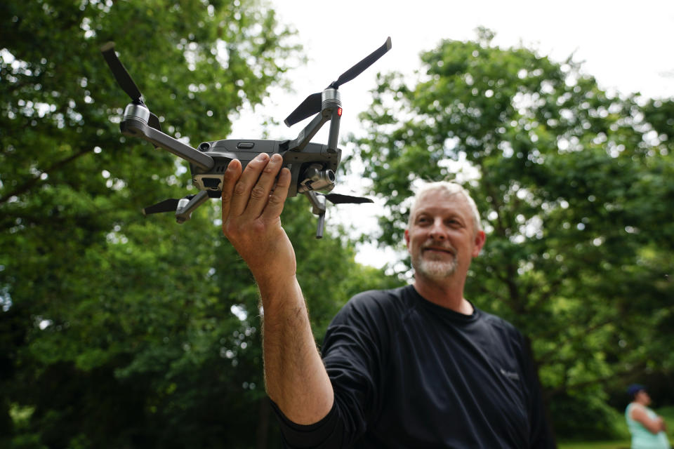 Brent Walls, the Upper Potomac Riverkeeper with Potomac Riverkeeper Network, shows how to catch a drone with his hand during a training session, Tuesday, June 7, 2022, in Poolesville, Md. Walls and other people who work to protect rivers and waterways have begun using drones to catch polluters in places where wrongdoing is difficult to see or expensive to find. The images they capture have already been used as evidence to formally accuse companies of wrongdoing. (AP Photo/Julio Cortez)