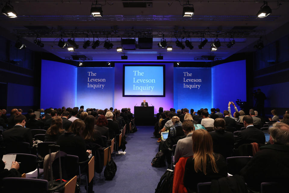 Britain's Lord Justice Brian Leveson, center back, delivers a statement following the release of the Leveson Inquiry report at the Queen Elizabeth II Centre, London, Thursday, Nov. 29, 2012. After a yearlong inquiry full of sensational testimony, Lord Justice Leveson released his report Thursday into the culture and practices of the British press and his recommendations for future regulation to prevent phone hacking, data theft, bribery and other abuses. (AP Photo/Dan Kitwood, Pool)