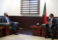 Sudanese Prime Minister Abdullah Hamdok, right, meets with British Foreign Secretary, Dominic Raab in the Cabinet Building, in Khartoum, Sudan, Thursday, Jan. 21, 2021. Raab was in the Sudanese capital Thursday to discuss bilateral relations and tensions along the border with Ethiopia, Sudan's state news agency reported. (AP Photo)