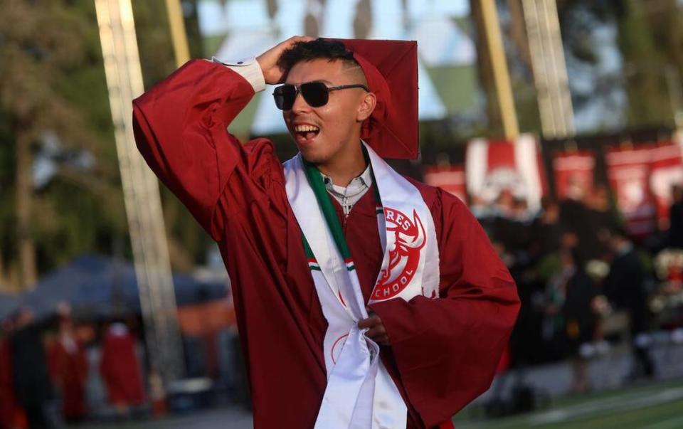 A graduate walks in at the start of the first graduation ceremony for Matilda Torres High School at Madera Memorial Stadium on June 10, 2023.