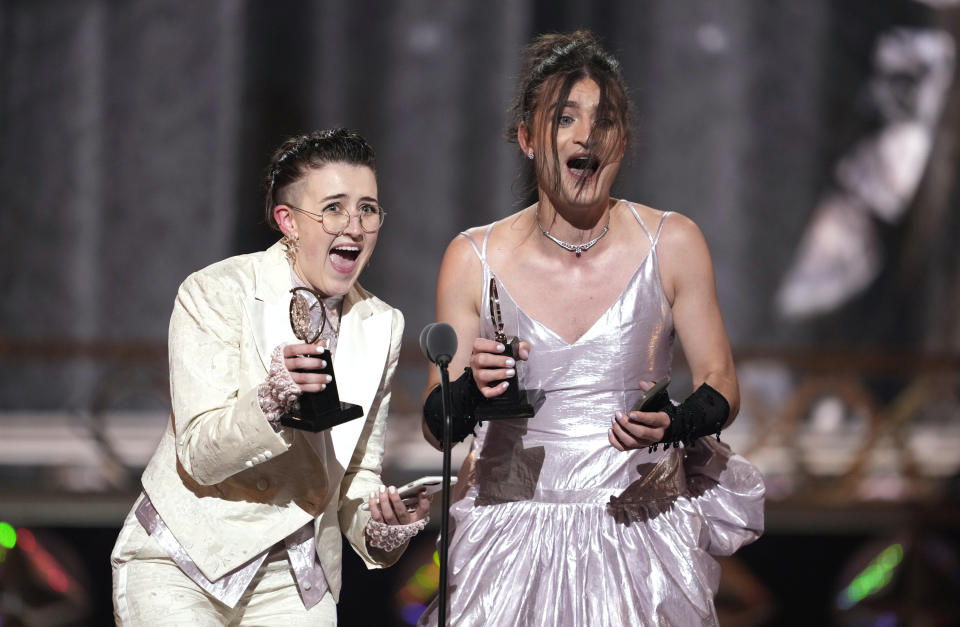 Lucy Moss, left, and Toby Marlow accept the award for best original score for "Six: The Musical" at the 75th annual Tony Awards on Sunday, June 12, 2022, at Radio City Music Hall in New York. (Photo by Charles Sykes/Invision/AP)