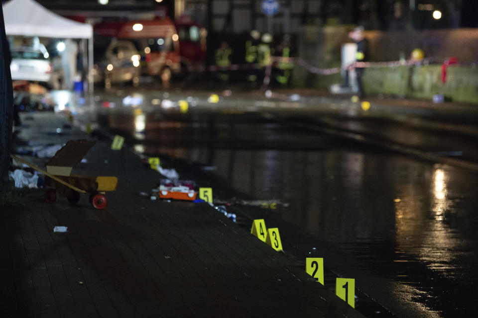 Investigators' markings are seen near the car that drove into a crowd of people during a carnival procession in Volkmarsen, Germany, Monday, Feb. 24, 2020. A man intentionally drove a car into a crowd of people at a Carnival parade in a small town in central Germany, injuring dozens of people including children, officials said Monday. Prosecutors said the driver, a 29-year-old local man, was arrested at the scene of the incident in Volkmarsen, about 280 kilometers (175 miles) southwest of Berlin. (Swen Pfortner/dpa via AP)