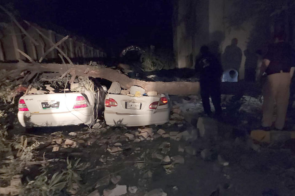 Plainclothes police officers examine the site of a bomb explosion, in Kabal, an area of Pakistan's Swat Valley, Monday, April 24, 2023. Two explosions Monday at a counterterrorism police facility in northwest Pakistan killed few people and wounded dozens, police said. (AP Photo/Sherin Zara)