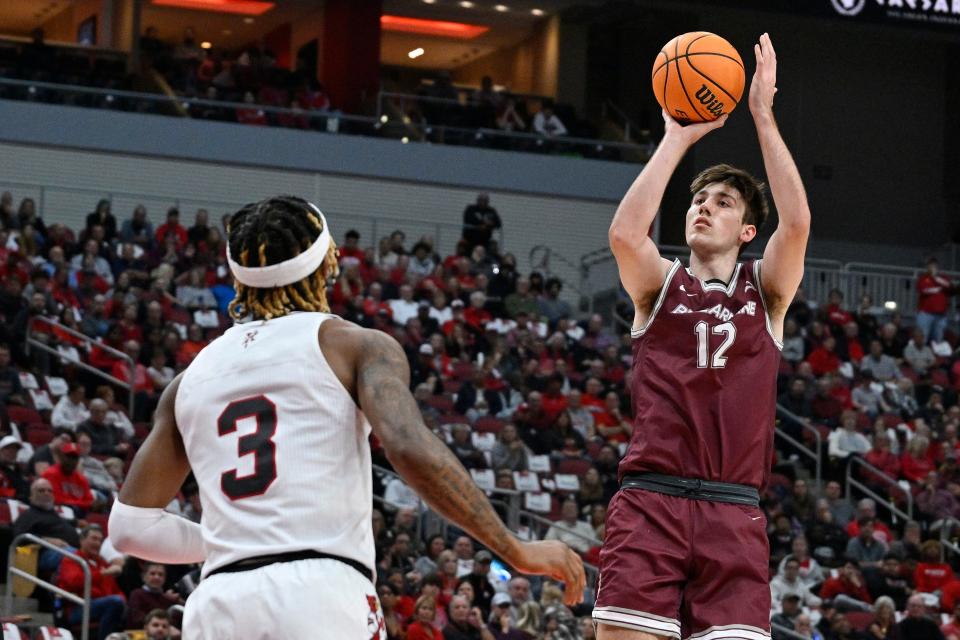 Nov 9, 2022; Louisville, Kentucky, USA; Bellarmine Knights forward Langdon Hatton (12) shoots against Louisville Cardinals guard El Ellis (3) during the first half at KFC Yum! Center. Mandatory Credit: Jamie Rhodes-USA TODAY Sports