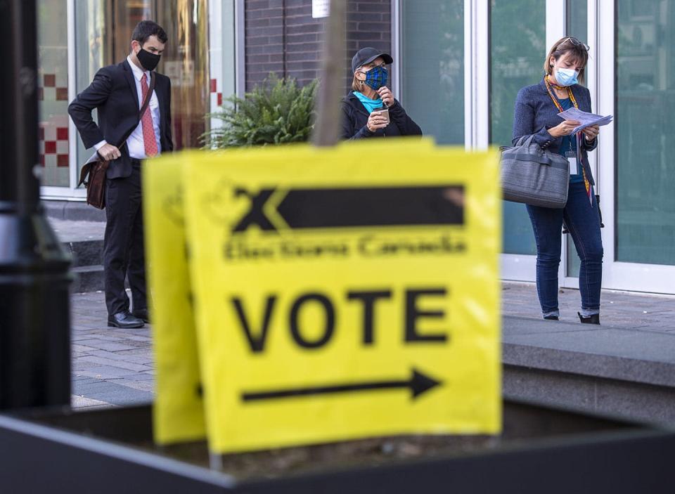 <span class="caption">Voters follow social distancing measures at the Halifax Convention Centre as they prepare to vote in the federal election in Halifax back in September. This year will bring about a host of significant political issues and events that will impact communities both locally and globally.</span> <span class="attribution"><span class="source">(THE CANADIAN PRESS/Andrew Vaughan)</span></span>