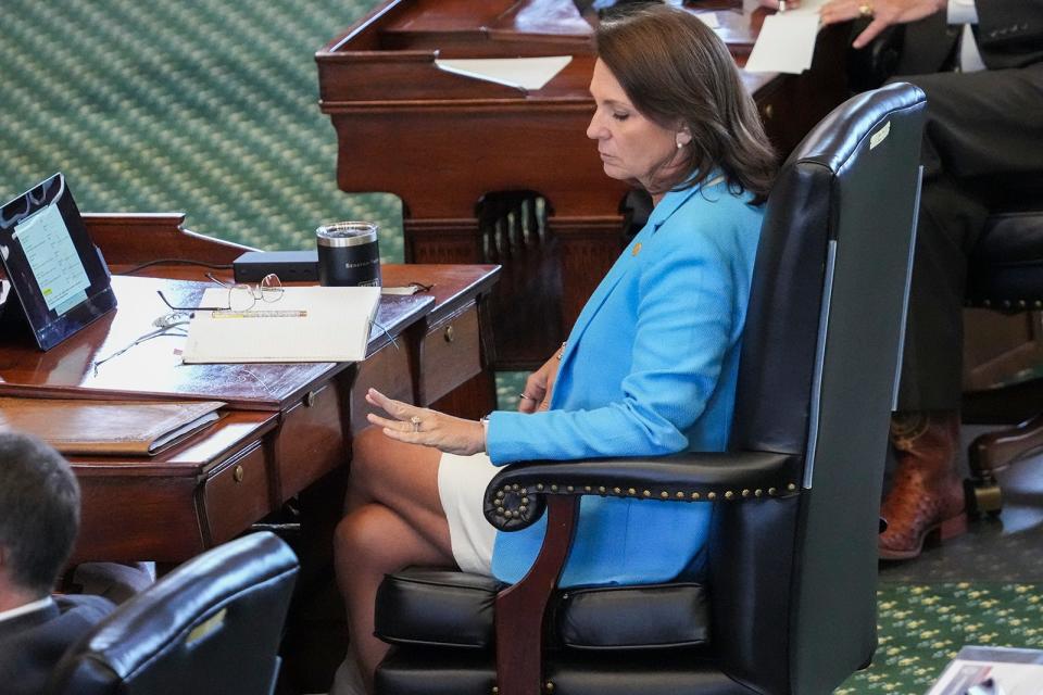 Sen. Angela Paxton, R-McKinney, looks down at her left hand Friday during her husband's impeachment trial.