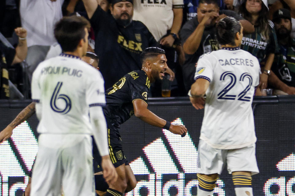 Los Angeles FC forward Denis Bouanga, center, celebrates after scoring against the LA Galaxy during the first half of an MLS playoff soccer match Thursday, Oct. 20, 2022, in Los Angeles. (AP Photo/Ringo H.W. Chiu)