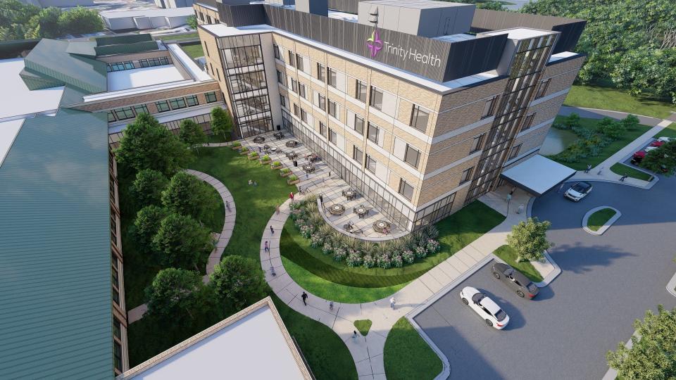 A rendering shows a four-story hospital addition planned at Trinity Health's health center near Brighton.