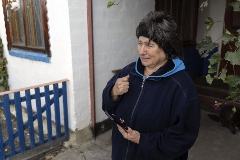 Liubov Kozyr, who lost her daughter and son-in-law in the attack, along with their son-in-law's parents, reacts in the village of Hroza near Kharkiv, Ukraine, Friday, Oct. 6, 2023. Ukrainian officials say at least 51 civilians were killed as the Russian rocket hit a village store and cafe in one of the deadliest attacks in recent months. (AP Photo/Alex Babenko)