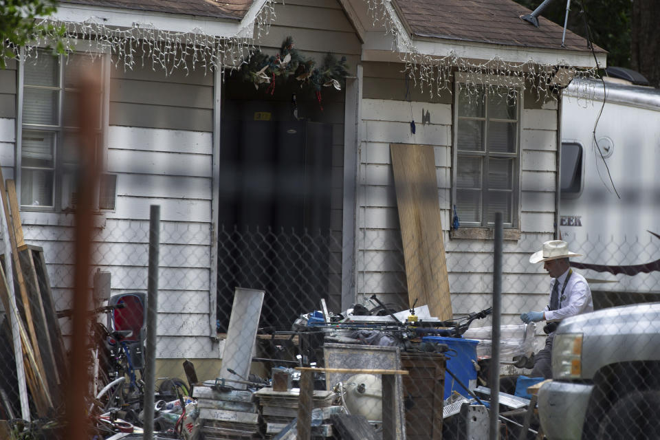 Law enforcement authorities responded to a scene where five people were shot the night before Saturday, April 29, 2023, in Cleveland, TX. Authorities say an 8-year-old child was among five people killed in a shooting at the home in southeast Texas late Friday night. (Yi-Chin Lee/Houston Chronicle via AP)