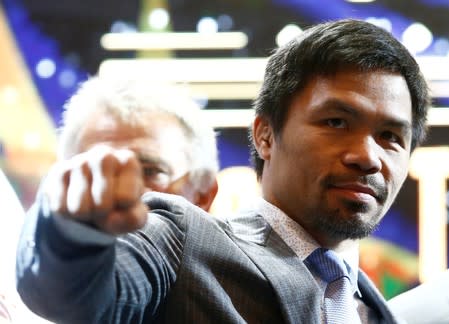 Philippine boxing icon Manny "Pacman" Pacquiao poses for photographers during a news conference in Kuala Lumpur