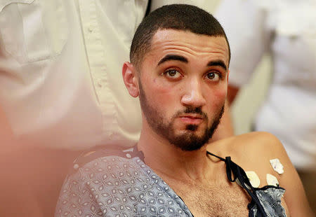 Suspect Emanuel Lopes, 20, looks on during his arraignment in the shooting deaths of Weymouth police officer Michael Chesna and a bystander, in District Court, in Quincy, Massachusetts, U.S., July 17, 2018. Greg Derr/The Patriot Ledger/Pool via REUTERS