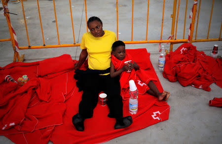 Migrants, intercepted aboard dinghies off the coast in the Strait of Gibraltar, rest in a makeshift emergency building after arriving on a rescue boat at the port of Barbate, southern Spain, July 27, 2018. REUTERS/Jon Nazca