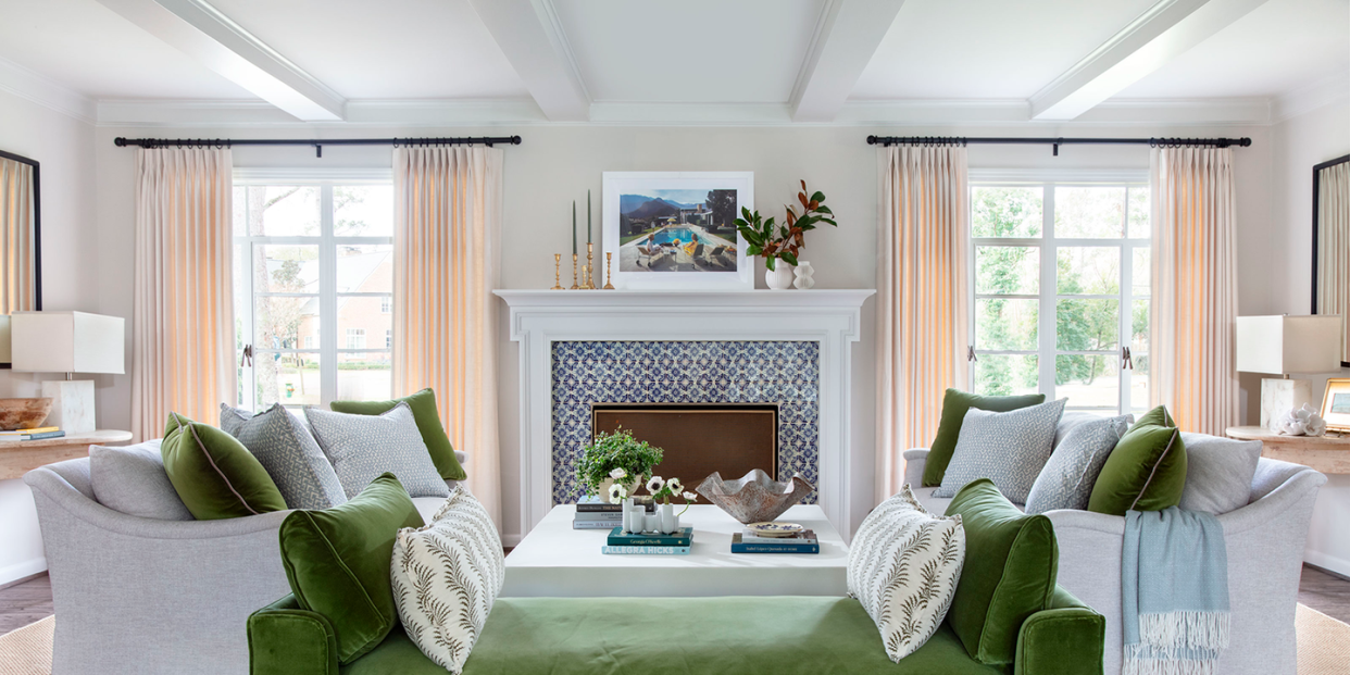 neutral living room with green bench and fireplace mantel