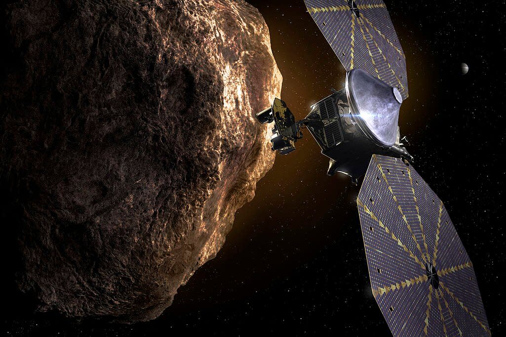 This illustration shows the Lucy spacecraft passing one of the Trojan Asteroids near Jupiter. Credits: Southwest Research Institute