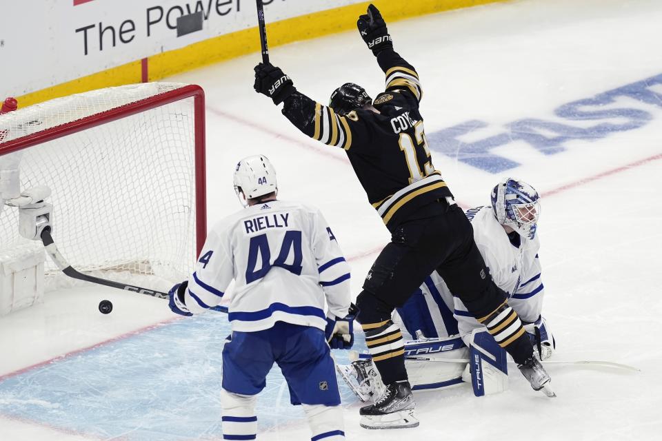 Boston Bruins' Charlie Coyle (13) celebrates a goal by Brandon Carlo against Toronto Maple Leafs goalie Ilya Samsonov, right, during the second period in Game 1 of an NHL hockey Stanley Cup first-round playoff series Saturday, April 20, 2024, in Boston. (AP Photo/Michael Dwyer)