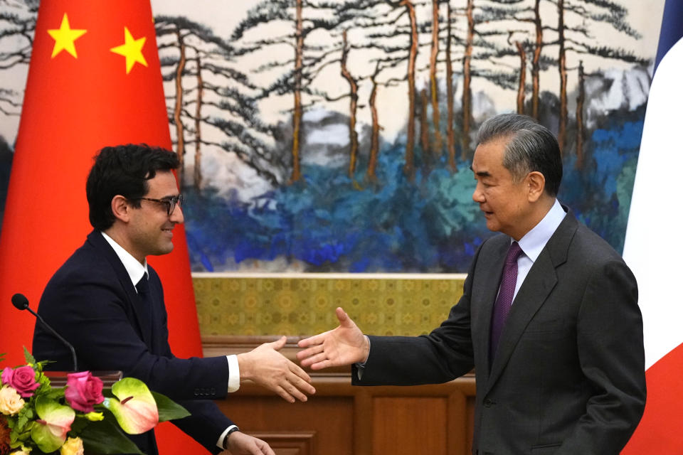 Chinese Foreign Minister Wang Yi, right, shakes hands with French Foreign Minister Stephane Sejourne, left, after a joint press conference at the Diaoyutai State Guesthouse in Beijing, China, Monday, April 1, 2024. (Ken Ishii/Pool Photo via AP)