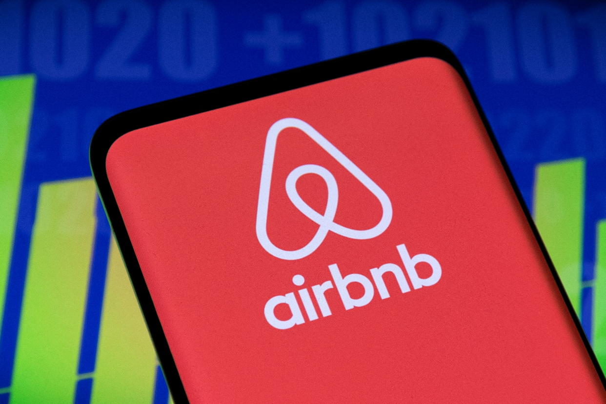 Airbnb logo and stock graph are seen displayed in this illustration taken, May 3, 2022. REUTERS/Dado Ruvic/Illustration