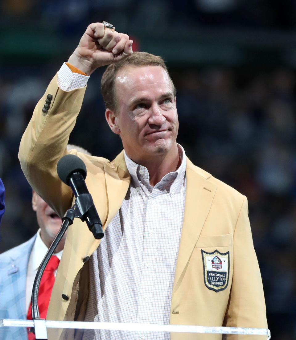 Peyton Manning pumps his fist in the air after receiving his hall of fame ring Sunday, Sept. 19, 2021, during halftime of a game against the Los Angeles Rams at Lucas Oil Stadium in Indianapolis.