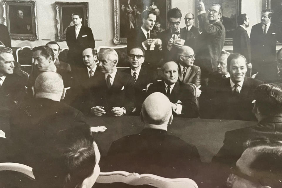 In this family handout photo, Roland Prinz, center, wearing a tie and holding a note pad, attends the Strategic Arms Limitation Talks 1 talks in Vienna, 1969. Prinz, who was born as armies began marching across central Europe then spent nearly four decades covering the Cold War and the fall of communism for The Associated Press, has died it was announced Friday, Dec 1, 2023. He was 85. (Family Handout via AP)