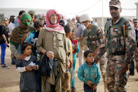 Syrian refugees wait to board a Jordanian army vehicle after crossing into Jordanian territory with their families, in Al Ruqban border area, near the northeastern Jordanian border with Syria, and Iraq, near the town of Ruwaished, 240 km (149 miles) east of Amman September 10, 2015. REUTERS/Muhammad Hamed/Files