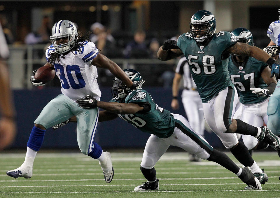 Chauncey Washington #30 of the Dallas Cowboys carries the ball against free safety Jaiquawn Jarrett #26 of the Philadelphia Eagles and defensive end Trent Cole #58 of the Philadelphia Eagles at Cowboys Stadium on December 24, 2011 in Arlington, Texas. The Philadelphia Eagles beat the Dallas Cowboys 20-7. (Photo by Tom Pennington/Getty Images)