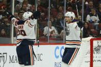 Edmonton Oilers right wing Alex Chiasson, right, celebrates his goal against the Arizona Coyotes with center Sam Gagner (89) during the second period of an NHL hockey game Sunday, Nov. 24, 2019, in Glendale, Ariz. (AP Photo/Ross D. Franklin)